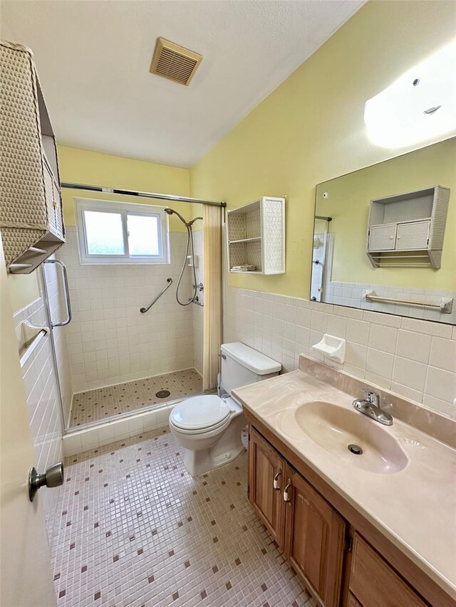 2360 Irish Ln Unit 16, Clearwater, FL 33763 - full bath featuring tile walls, toilet, tile patterned floors, a stall shower, and vanity