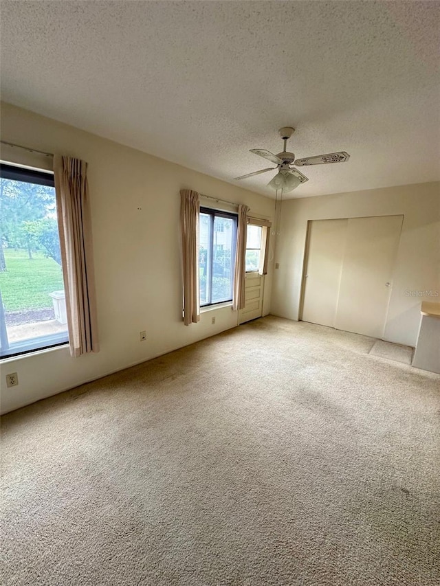 2360 Irish Ln Unit 16, Clearwater, FL 33763 - unfurnished bedroom with light carpet, a textured ceiling, a ceiling fan, and a closet