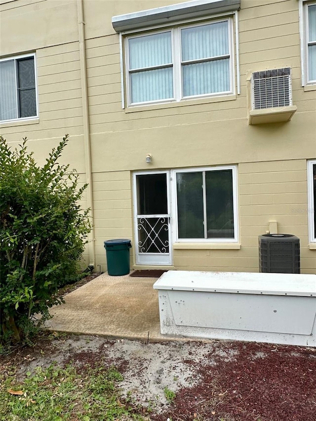 2360 Irish Ln Unit 16, Clearwater, FL 33763 - rear view of property featuring central air condition unit and a patio area