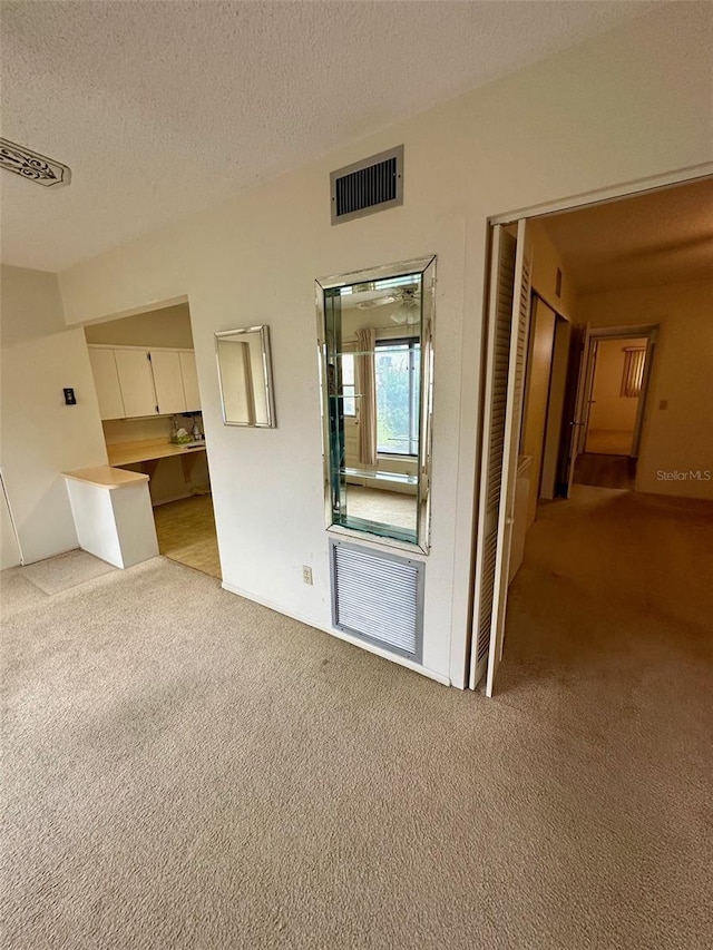 2360 Irish Ln Unit 16, Clearwater, FL 33763 - unfurnished room with light colored carpet and a textured ceiling