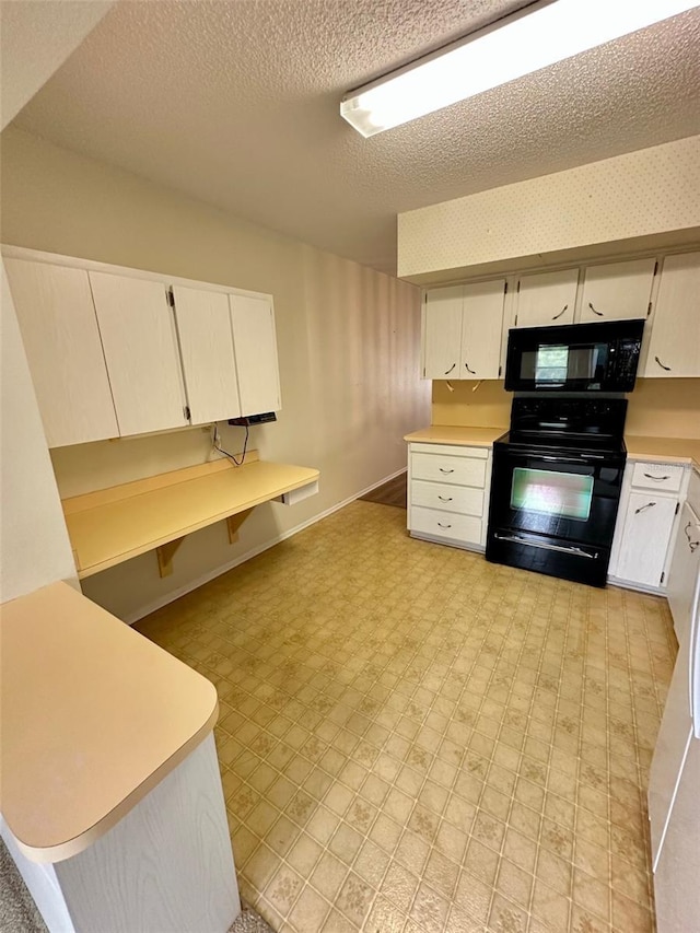 2360 Irish Ln Unit 16, Clearwater, FL 33763 - kitchen with black appliances, light countertops, white cabinetry, a textured ceiling, and light flooring
