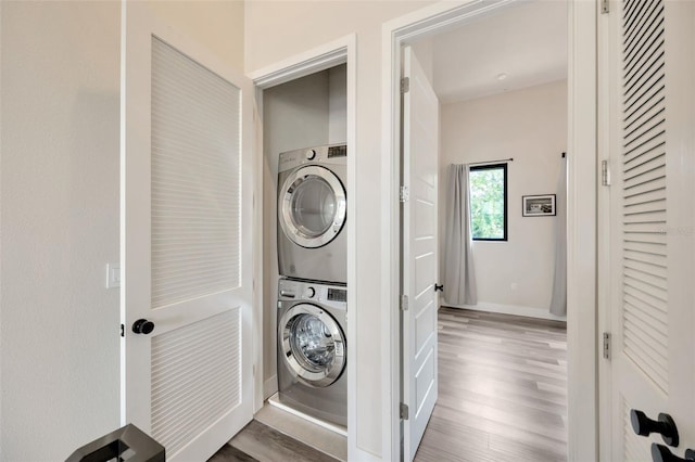 4047 Gauge Line Loop, Tampa, FL 33624 - laundry room with stacked washer / dryer, wood finished floors, and baseboards