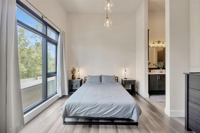 4047 Gauge Line Loop, Tampa, FL 33624 - bedroom with wood finished floors, baseboards, and connected bathroom