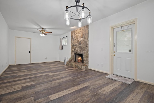 3413 W Kirby St, Tampa, FL 33614 - unfurnished living room featuring wood finished floors, a ceiling fan, a chandelier, and a fireplace