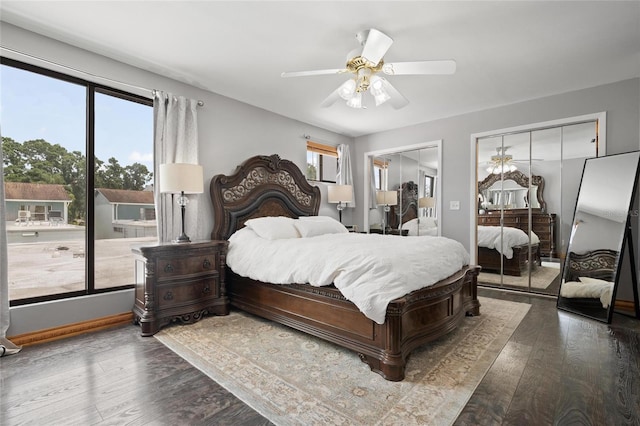 3413 W Kirby St, Tampa, FL 33614 - bedroom with two closets, wood finished floors, ceiling fan, and baseboards