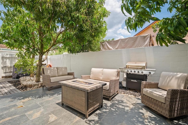 3413 W Kirby St, Tampa, FL 33614 - view of patio / terrace with grilling area, an outdoor living space with a fire pit, and a fenced backyard