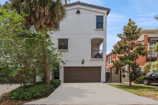 412 S Albany Ave Unit 2, Tampa, FL 33606 - view of front of house featuring stucco siding, an attached garage, driveway, a balcony, and fence