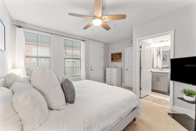 412 S Albany Ave Unit 2, Tampa, FL 33606 - bedroom with ensuite bath, light wood finished floors, a ceiling fan, baseboards, and a sink