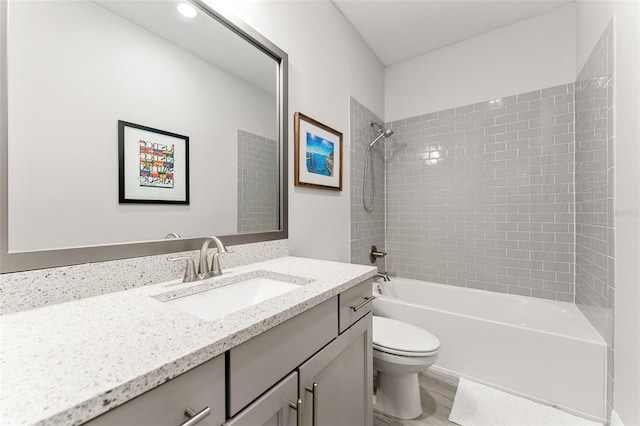 412 S Albany Ave Unit 2, Tampa, FL 33606 - bathroom featuring toilet, vanity, shower / bath combination, and wood finished floors
