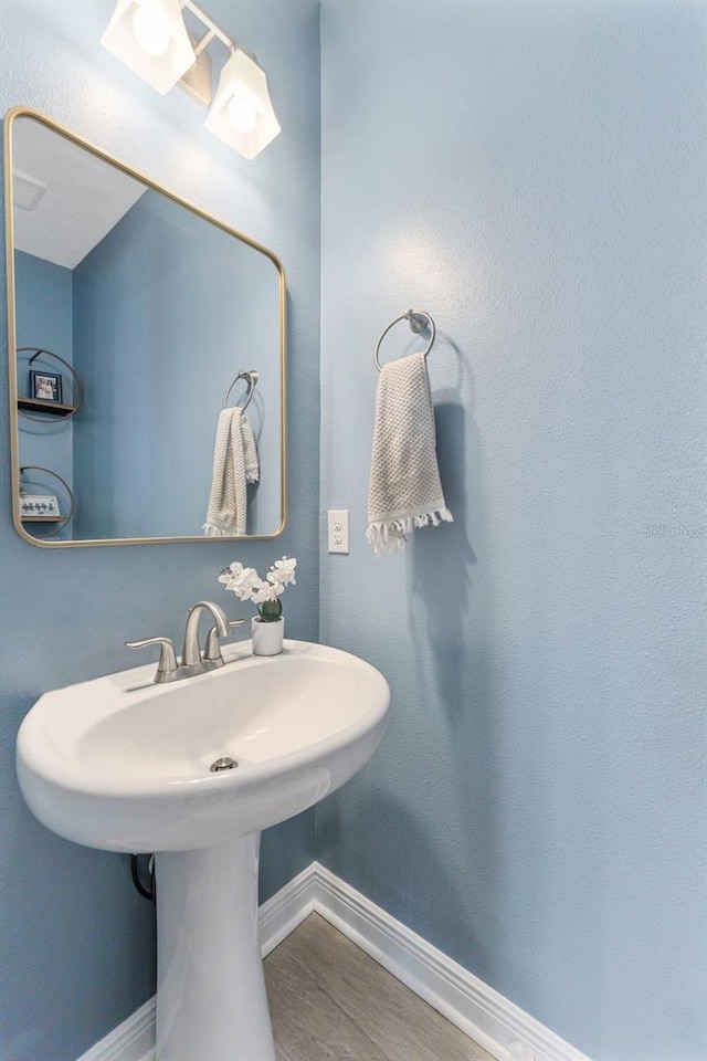 412 S Albany Ave Unit 2, Tampa, FL 33606 - bathroom with baseboards, wood finished floors, and a sink