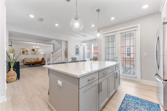 412 S Albany Ave Unit 2, Tampa, FL 33606 - kitchen with freestanding refrigerator, light wood-style flooring, open floor plan, a kitchen island, and recessed lighting