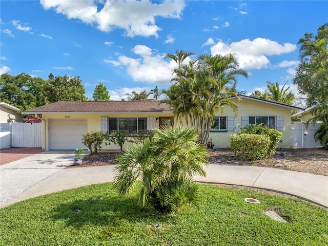 3843 Neptune Dr SE, Saint Petersburg, FL 33705 - single story home with a gate, concrete driveway, a garage, and stucco siding