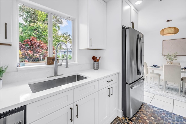 3843 Neptune Dr SE, Saint Petersburg, FL 33705 - kitchen featuring appliances with stainless steel finishes, a sink, white cabinets, light countertops, and recessed lighting