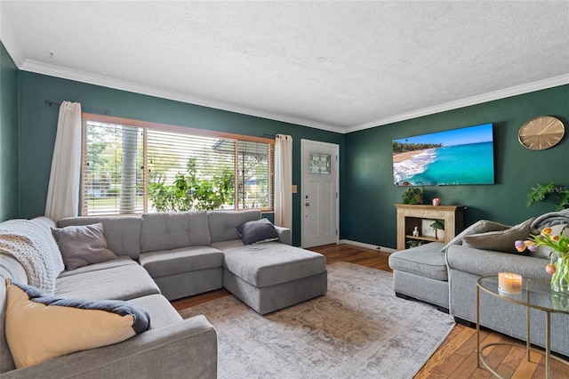 living room with a textured ceiling, ornamental molding, and wood finished floors