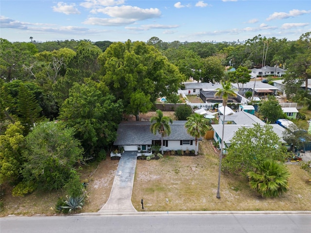 view from above of property with a heavily wooded area