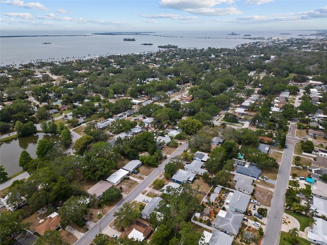 aerial overview of property's location with a nearby body of water and nearby suburban area