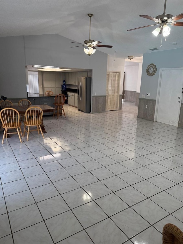 2026 Aaron Pl, Clearwater, FL 33760 - living area featuring a ceiling fan, vaulted ceiling, and light tile patterned floors