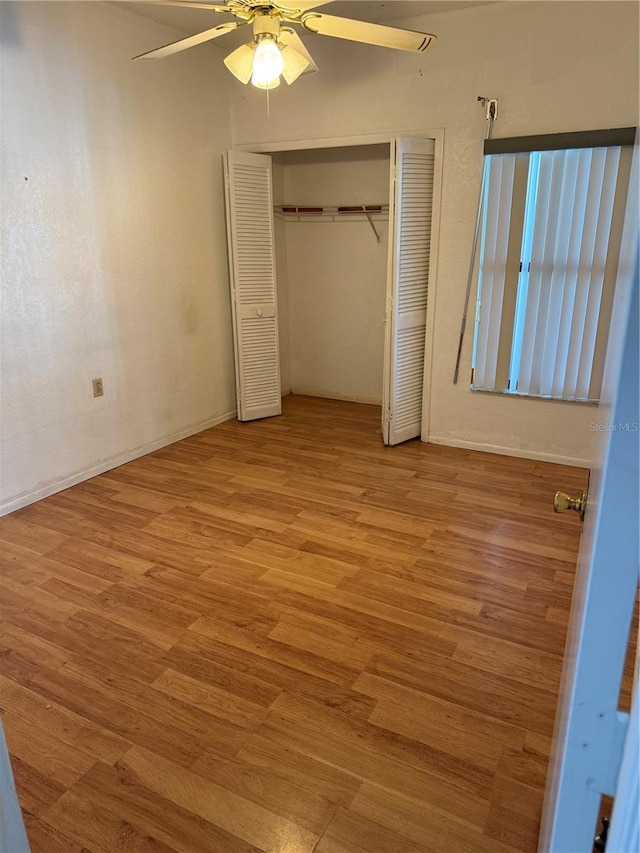 2026 Aaron Pl, Clearwater, FL 33760 - unfurnished bedroom featuring wood finished floors, a closet, ceiling fan, and baseboards