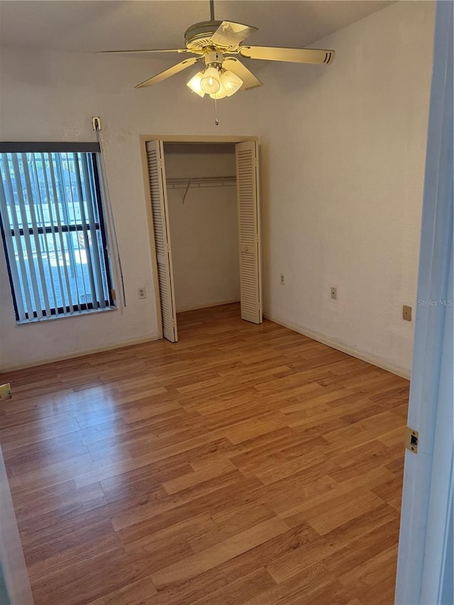 2026 Aaron Pl, Clearwater, FL 33760 - unfurnished bedroom with light wood-type flooring, a ceiling fan, and a closet