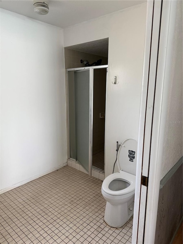2026 Aaron Pl, Clearwater, FL 33760 - bathroom with a stall shower, tile patterned floors, and toilet