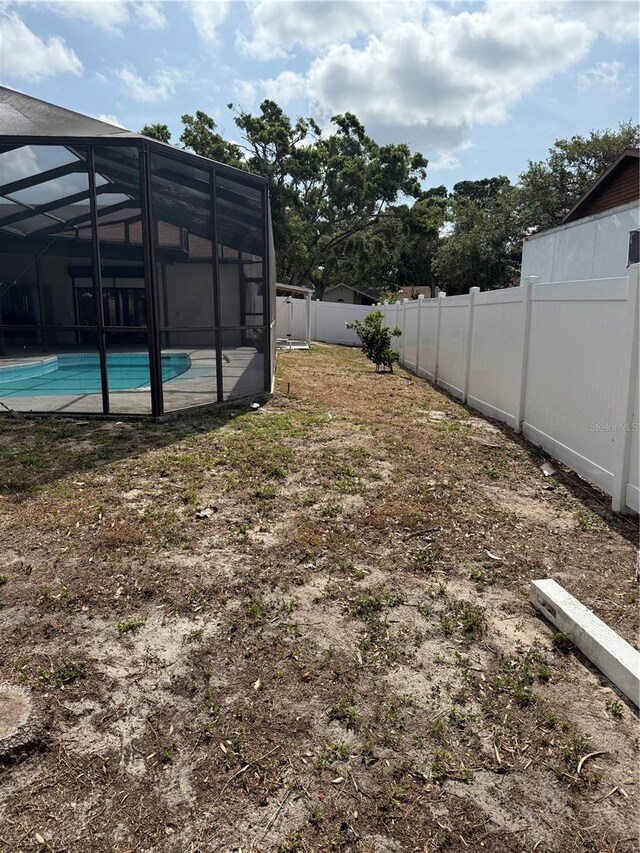 2026 Aaron Pl, Clearwater, FL 33760 - fenced backyard with a lanai
