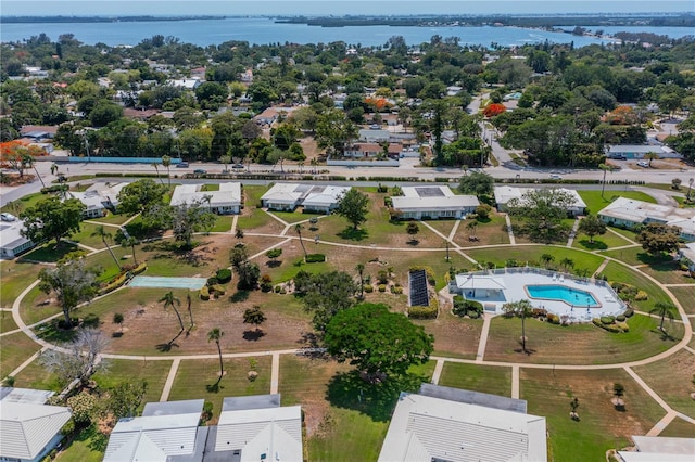 aerial view of residential area featuring a large body of water and a pool area
