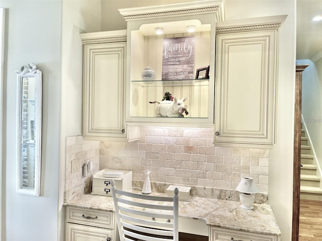 919 Ballinger Rd, Lutz, FL 33548 - kitchen featuring cream cabinetry, decorative backsplash, and light stone countertops