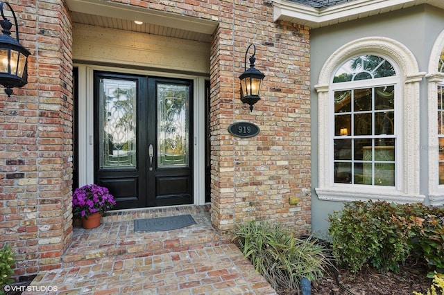 919 Ballinger Rd, Lutz, FL 33548 - property entrance featuring french doors, brick siding, and stucco siding