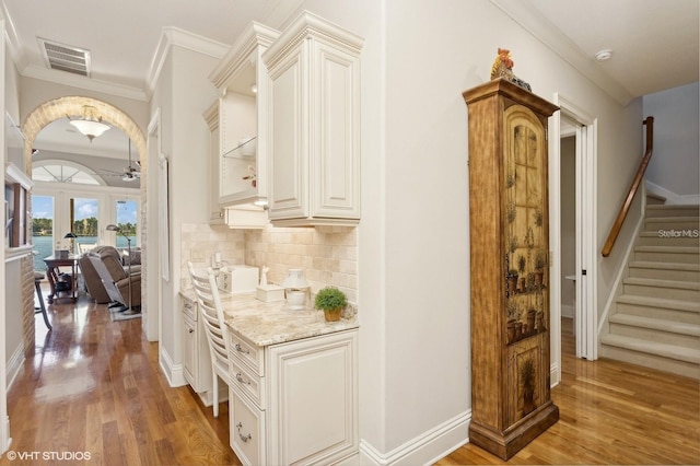 919 Ballinger Rd, Lutz, FL 33548 - corridor featuring crown molding, light wood-type flooring, and stairs