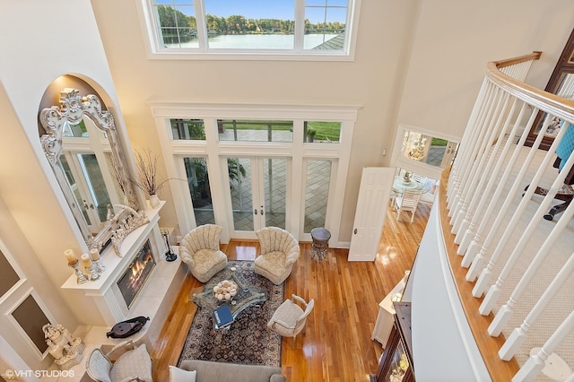919 Ballinger Rd, Lutz, FL 33548 - foyer entrance featuring a high ceiling, french doors, stairs, wood finished floors, and a tiled fireplace