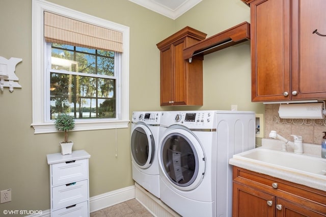 919 Ballinger Rd, Lutz, FL 33548 - laundry room featuring cabinet space, washer and clothes dryer, and ornamental molding
