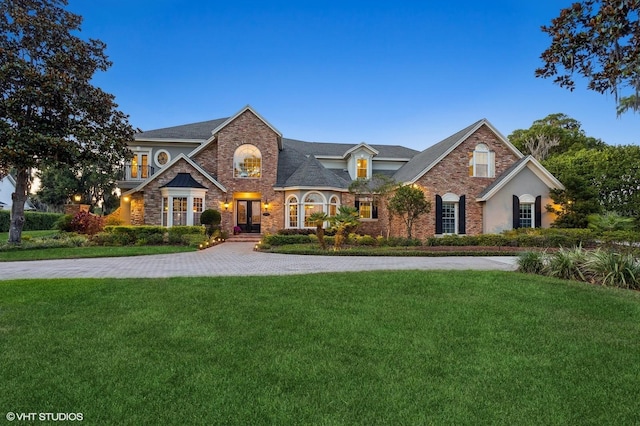 919 Ballinger Rd, Lutz, FL 33548 - view of front of home with a front lawn, french doors, stone siding, and brick siding