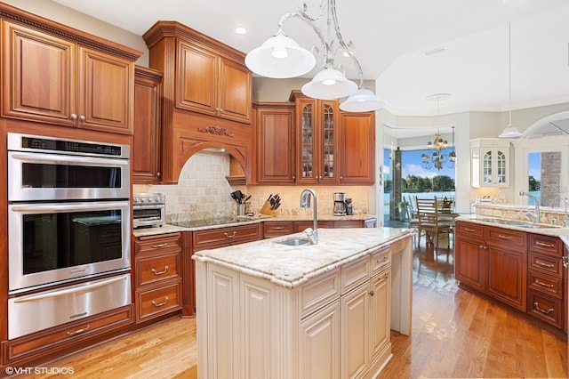 919 Ballinger Rd, Lutz, FL 33548 - kitchen featuring a warming drawer, double oven, light wood-type flooring, light stone countertops, and recessed lighting