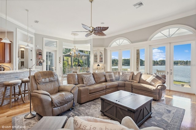 919 Ballinger Rd, Lutz, FL 33548 - living area featuring light wood-style flooring, crown molding, french doors, a water view, and ceiling fan