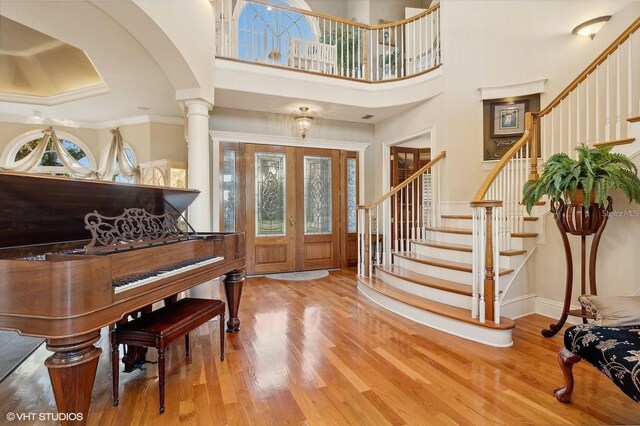 919 Ballinger Rd, Lutz, FL 33548 - foyer entrance with wood finished floors, stairs, a towering ceiling, ornamental molding, and arched walkways