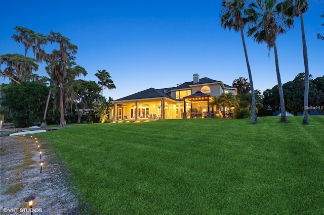 919 Ballinger Rd, Lutz, FL 33548 - back of house with a yard and a chimney