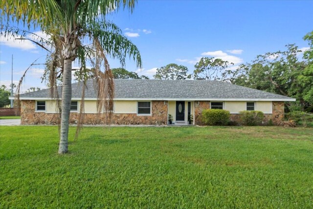 903 Tomahawk Trl, Brandon, FL 33511 - single story home with stone siding, a front lawn, and stucco siding