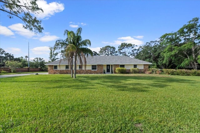 903 Tomahawk Trl, Brandon, FL 33511 - ranch-style house featuring a front yard, stone siding, and driveway