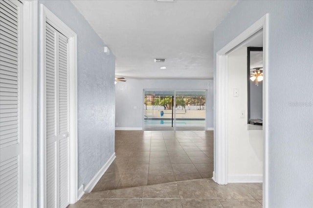903 Tomahawk Trl, Brandon, FL 33511 - hall with tile patterned floors and baseboards