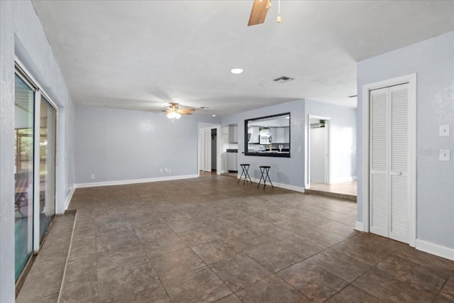 903 Tomahawk Trl, Brandon, FL 33511 - unfurnished living room featuring a ceiling fan and baseboards