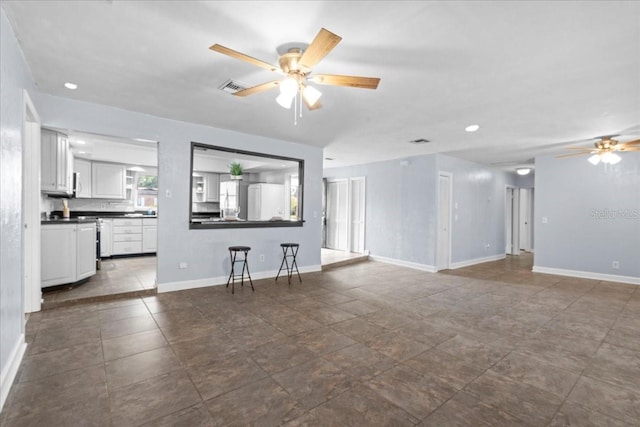 903 Tomahawk Trl, Brandon, FL 33511 - unfurnished living room with ceiling fan, baseboards, and recessed lighting