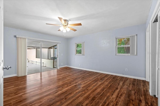 903 Tomahawk Trl, Brandon, FL 33511 - unfurnished bedroom featuring access to exterior, wood finished floors, baseboards, and ceiling fan