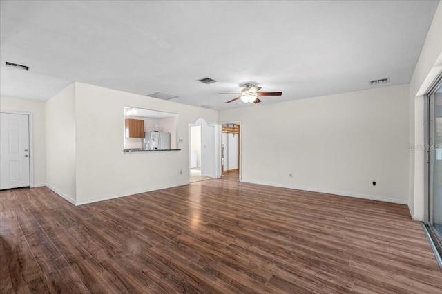 903 Tomahawk Trl, Brandon, FL 33511 - unfurnished living room with ceiling fan, wood finished floors, and baseboards