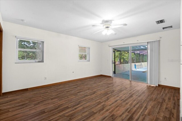 903 Tomahawk Trl, Brandon, FL 33511 - spare room with plenty of natural light, dark wood finished floors, ceiling fan, and baseboards