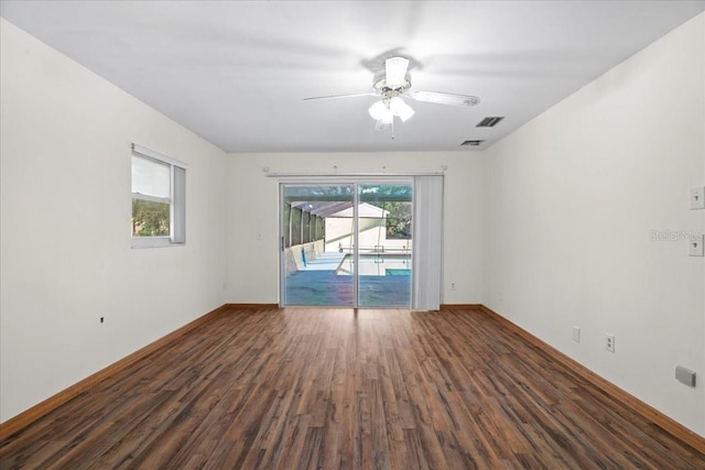 903 Tomahawk Trl, Brandon, FL 33511 - spare room featuring wood finished floors, healthy amount of natural light, and baseboards