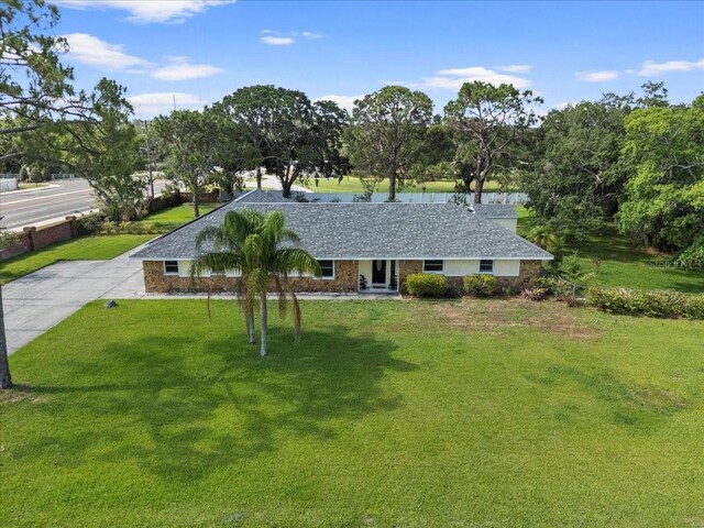 903 Tomahawk Trl, Brandon, FL 33511 - ranch-style house with a front lawn and view of scattered trees