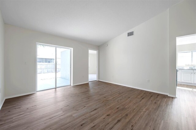 unfurnished living room featuring wood finished floors and baseboards