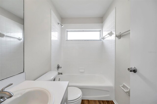 full bathroom with toilet, vanity, shower / bath combination, and wood finished floors