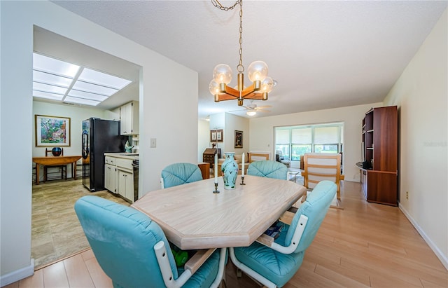 368 Perth Ct Unit 368, Dunedin, FL 34698 - dining space featuring a chandelier, light wood-type flooring, and baseboards