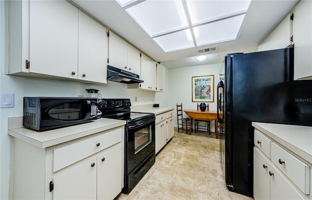 368 Perth Ct Unit 368, Dunedin, FL 34698 - kitchen with black appliances, under cabinet range hood, light countertops, and white cabinets